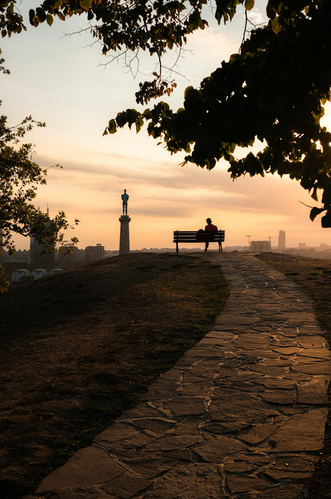 person walking on path at sunrise