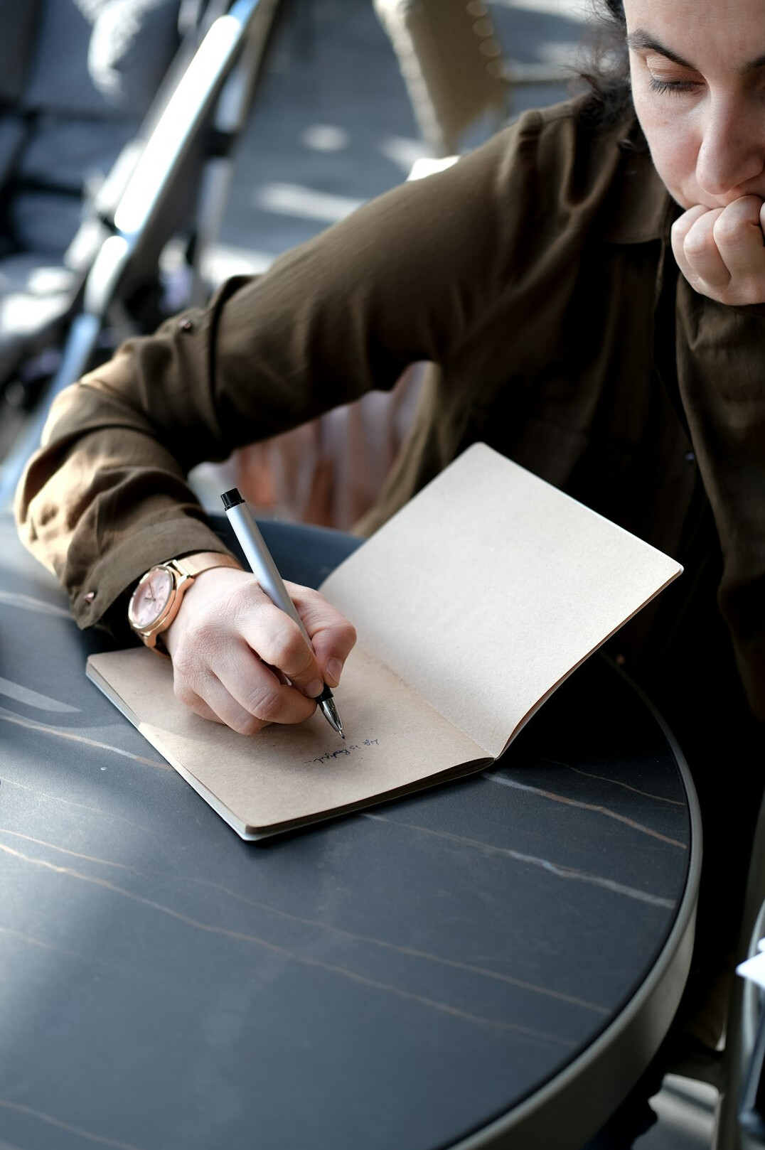 man writing in journal